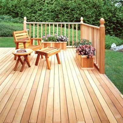 A wooden deck with chairs and tables on it.